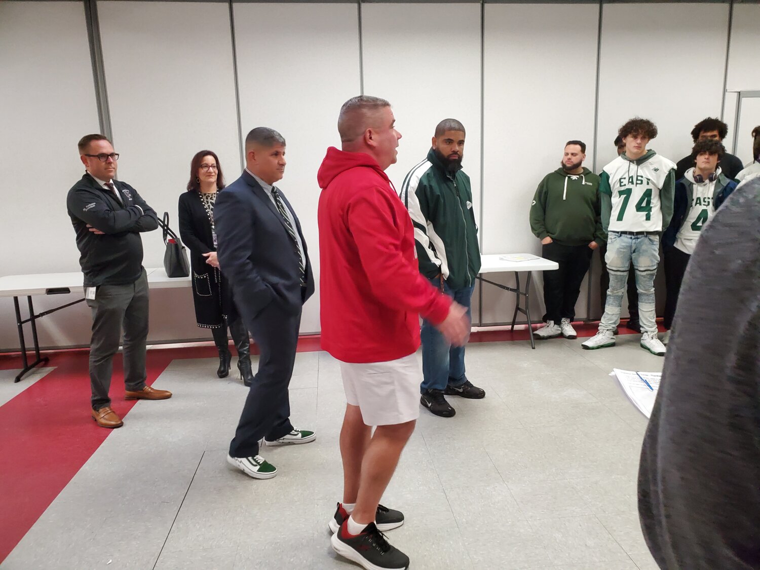 A COACH’S WISDOM: coaches Milewski (red) and McDaniel (green) speak with their players before sending them out to make their deliveries.